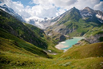 Scenic view of mountains against cloudy sky