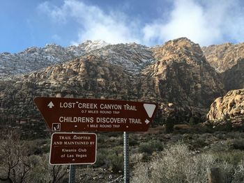 Information sign against rocky mountains at canyon creek trailhead