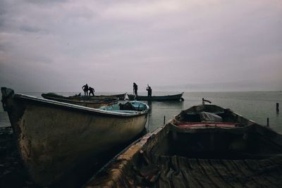 Boats moored on sea against sky