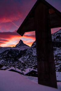 Scenic view of snowcapped mountains against sky during sunset