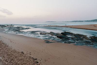 Scenic view of beach against sky during sunset