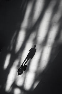 High angle view of people walking on tiled floor