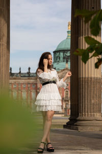 Full length of woman standing against sky