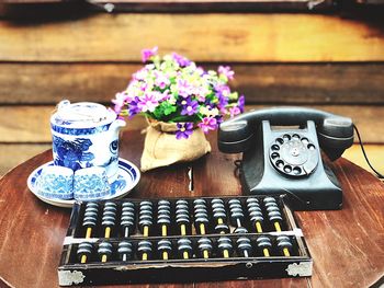 High angle view of various flowers on table with dial telephone abacus show vintage style 