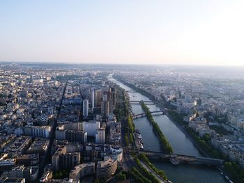 High angle view of river amidst buildings in city against clear sky