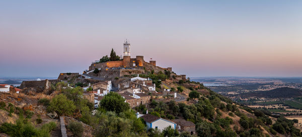 Panoramic view of buildings in city against sky