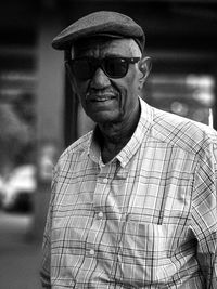 Portrait of man wearing sunglasses standing outdoors