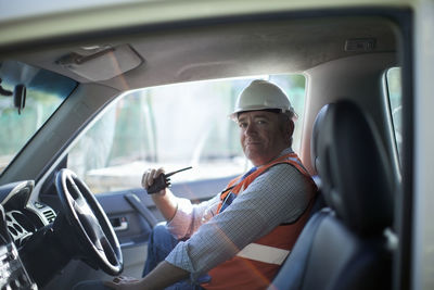 Midsection of man sitting in car