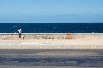 Man on beach against sky