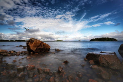 Rocks on beach against sky