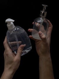 Close-up of man holding glass bottle