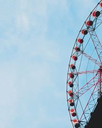 Low angle view of ferris wheel against sky