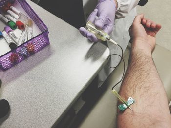 Cropped image of nurse giving treatment to patient at hospital