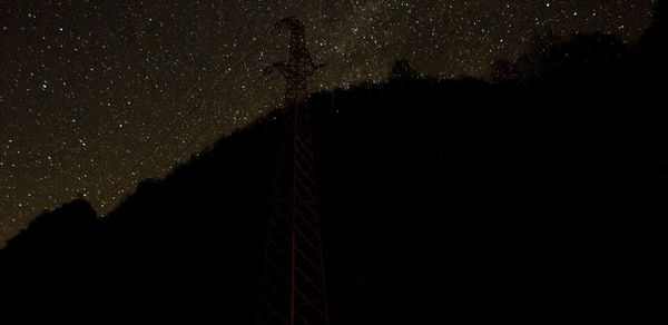 Low angle view of silhouette tree against sky at night