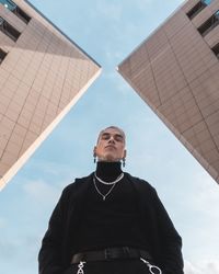 Low angle view of man standing against sky