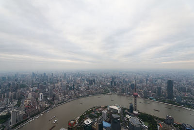 High angle view of city buildings against sky