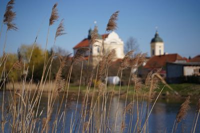 Panoramic view of lake and buildings against sky