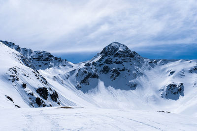 Scenic view of snow covered mountains against sky