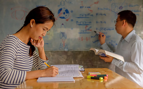 Colleagues working at desk in office