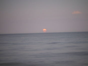 Scenic view of sea against clear sky during sunset