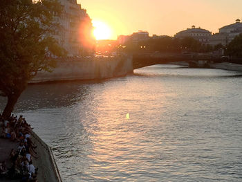 Bridge over river at sunset