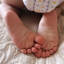 Close-up of baby feet on bed