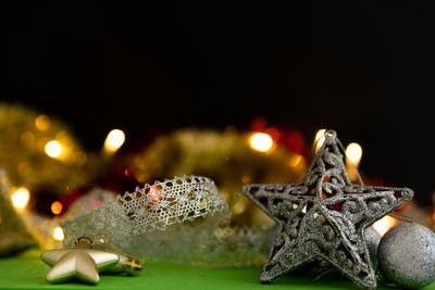 Close-up of illuminated christmas decorations on table