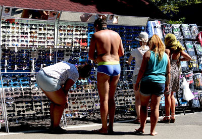 Rear view of women standing at store