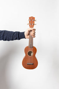 Man playing guitar against white background