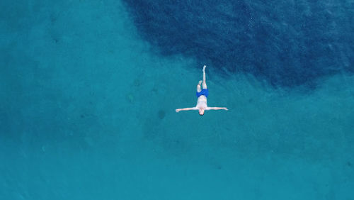 High angle view of young woman swimming in sea