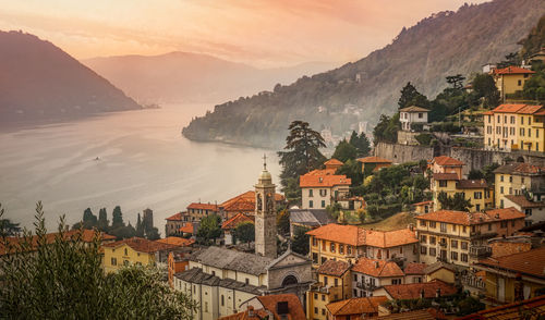 High angle view of townscape by mountain against sky