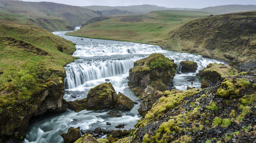 Scenic view of river flowing through rocks