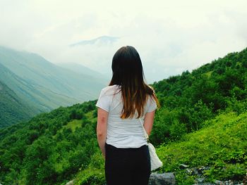 Rear view of woman looking at mountains