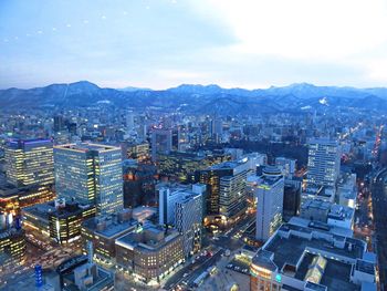 Aerial view of city lit up at night