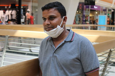 Man wearing mask standing in restaurant