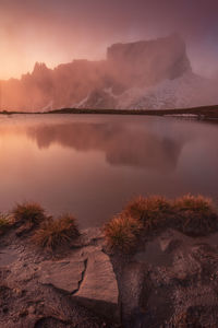 Scenic view of lake against sky during sunset