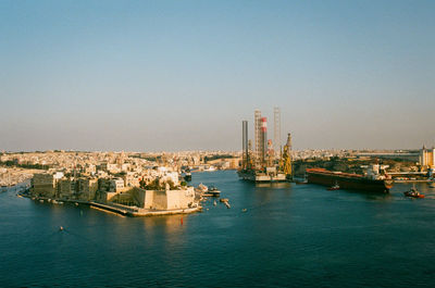 Panoramic view of sea and buildings against clear sky