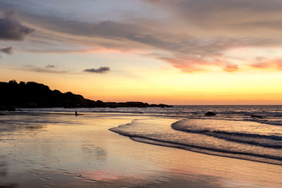 Scenic view of beach against sky during sunset