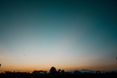 Scenic view of silhouette landscape against clear sky at sunset