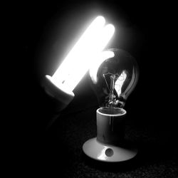 Close-up of illuminated lamp in darkroom