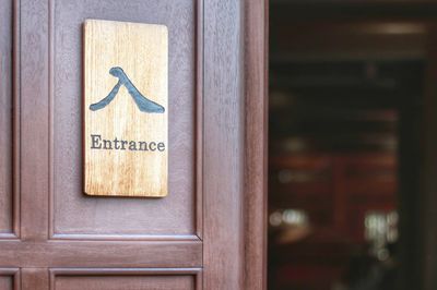 Close-up of text on wooden door