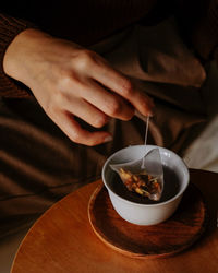 Midsection of man holding coffee