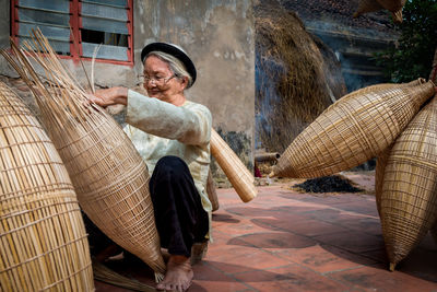 Full length portrait of man holding basket