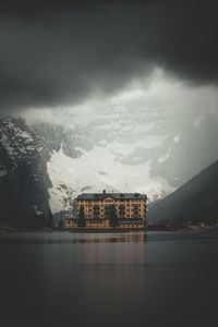 Scenic view of lake by building against sky