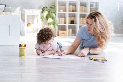 High angle view of girl studying at table