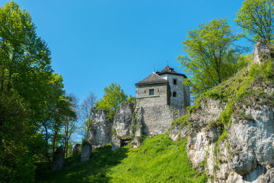 Low angle view of castle against clear blue sky