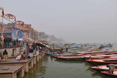 Boats moored in river against clear sky