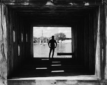 Silhouette man walking in corridor of building