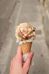 Cropped image of hand holding ice cream