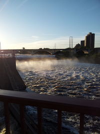 Bridge over river with buildings in background